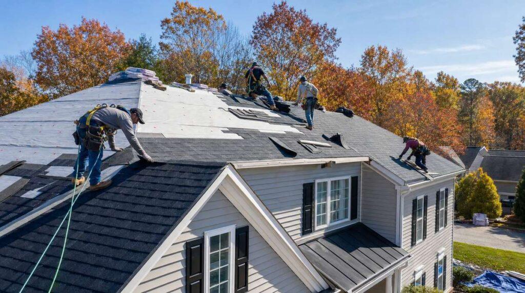 Roofing crew installing new asphalt shingles on a suburban Georgia home